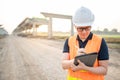 Asian worker using digital tablet at construction site Royalty Free Stock Photo