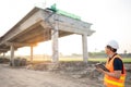 Asian worker using digital tablet at construction site Royalty Free Stock Photo