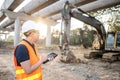 Asian worker using digital tablet at construction site Royalty Free Stock Photo