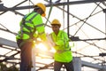 Asian worker wear safety equipment handing bricks to each other. Teamwork concept in the construction site