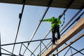 Asian worker wear safety height equipment to install the roof in the construction site;. Fall arrestor device for worker with Royalty Free Stock Photo