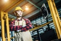 Asian worker wearing the goggle, helmet, ear muff equipment in production plant Royalty Free Stock Photo