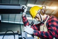 Asian worker wearing the goggle, helmet, ear muff equipment in production plant Royalty Free Stock Photo