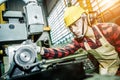 Asian worker wering the goggle, helmet, ear muff equipment in production plant Royalty Free Stock Photo