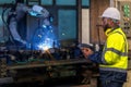 Asian worker working in old chinese factory in robot auto welding machine section Royalty Free Stock Photo