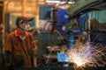 Asian worker working in old chinese factory in robot auto welding machine section