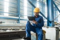 Asian worker writing observations about manufacturing