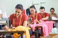 Asian workers in garment factory sewing with industrial sewing m Royalty Free Stock Photo