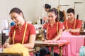 Asian workers in garment factory sewing with industrial sewing m Royalty Free Stock Photo