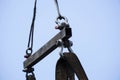 Crane boom with isolated hook blue sky background Elements of crane: hook loop chain connecting parts