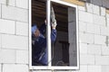 Asian workers install windows to the house