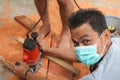 Asian workers using electric routering cut the wood and sawdust Royalty Free Stock Photo