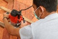 Asian workers using electric routering to cut the wood and sawdust Royalty Free Stock Photo