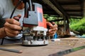 Asian workers using electric routering to cut the wood. Royalty Free Stock Photo