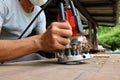 Asian workers using electric routering to cut the wood. Royalty Free Stock Photo