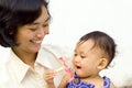 Asian working mother and baby Royalty Free Stock Photo