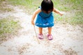 Asian one year old toddler is busy playing in a tropical park in the morning