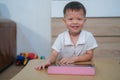 Asian 2 - 3 years old toddler boy child smiling and looking at camera while using tablet pc computer, Learning Tablet for Kids