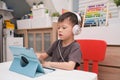 Asian 4 years old toddler boy child using tablet pc computer, Child at home during the Covid-19 health crisis, Distance Learning, Royalty Free Stock Photo