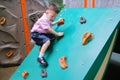 Asian 2 - 3 years old toddler child having fun trying to climb on artificial boulders at schoolyard playground, Little boy Royalty Free Stock Photo