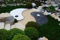 Asian Yin and Yang symbol of contrary and complementary forces made as stone decoration with pathway in Mu-Shin garden