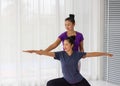 Asian yoga teachers teach students one-on-one in gym to be healthy and strong