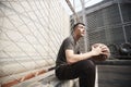 Young asian basketball player resting at courtside Royalty Free Stock Photo