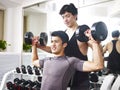 Asian young adult working out in gym Royalty Free Stock Photo