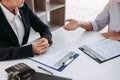 Asian young adult sitting at desk across from manager being interviewed job interview in business room