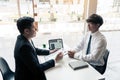 Asian young adult sitting at desk across from manager being interviewed job interview in business room