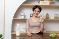Asian young beautiful woman drinking glass of milk in kitchen at home. health care concept Royalty Free Stock Photo