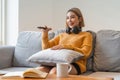 Asian young beautiful woman watch fun movie on television at home. woman casual girl feel happy and relax sit on sofa Royalty Free Stock Photo