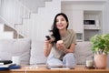 Asian young beautiful woman watching fun movie on television at home. Attractive casual girl feel happy and relax, sit Royalty Free Stock Photo