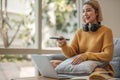 Asian young beautiful woman watching fun movie on television at home. Attractive casual girl feel happy and relax, sit Royalty Free Stock Photo