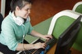 Asian young blind woman with headphone using computer with refreshable braille display or braille terminal a technology device for Royalty Free Stock Photo