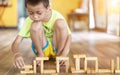 Asian young boy playing blocks wood game on the floor Royalty Free Stock Photo