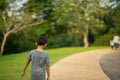 Asian young boy walking alone in the park