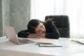 Asian young business girl sleeping on the desk in front a laptop Royalty Free Stock Photo