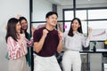 Asian young business man and his colleagues wearing casual shirt is smiling and very happy with his success in office. Working, Royalty Free Stock Photo