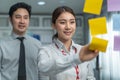 Asian young business people group have discussion meeting in office. Man and woman have brainstorming and working together as Royalty Free Stock Photo