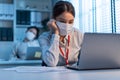 Asian young business woman wear mask, feel tired from work in office. Man and woman employee worker use computer on table overwork