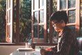 Asian young business young man wearing glasses of a student holding a pencil writing the letter on paper at home Royalty Free Stock Photo