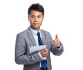 Asian young businessman hold with tablet pc and thumb up Royalty Free Stock Photo