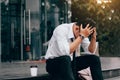 Asian young businessman stress sitting in front office with his Royalty Free Stock Photo