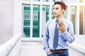 Asian young Businessman use a Smart Phone and Look forward, Comm Royalty Free Stock Photo