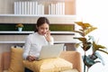 Asian young Businesswoman working laptop computer on wood desk in Home Royalty Free Stock Photo