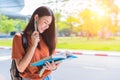 Asian young college woman doing homework and reading books for f