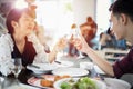 Asian young couple enjoying a romantic dinner  evening drinks while sitting at the dinning table on the kitchen together Royalty Free Stock Photo