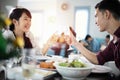 Asian young couple enjoying a romantic dinner  evening drinks while sitting at the dinning table on the kitchen together Royalty Free Stock Photo