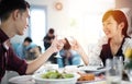 Asian young couple enjoying a romantic dinner  evening drinks while sitting at the dinning table on the kitchen together Royalty Free Stock Photo